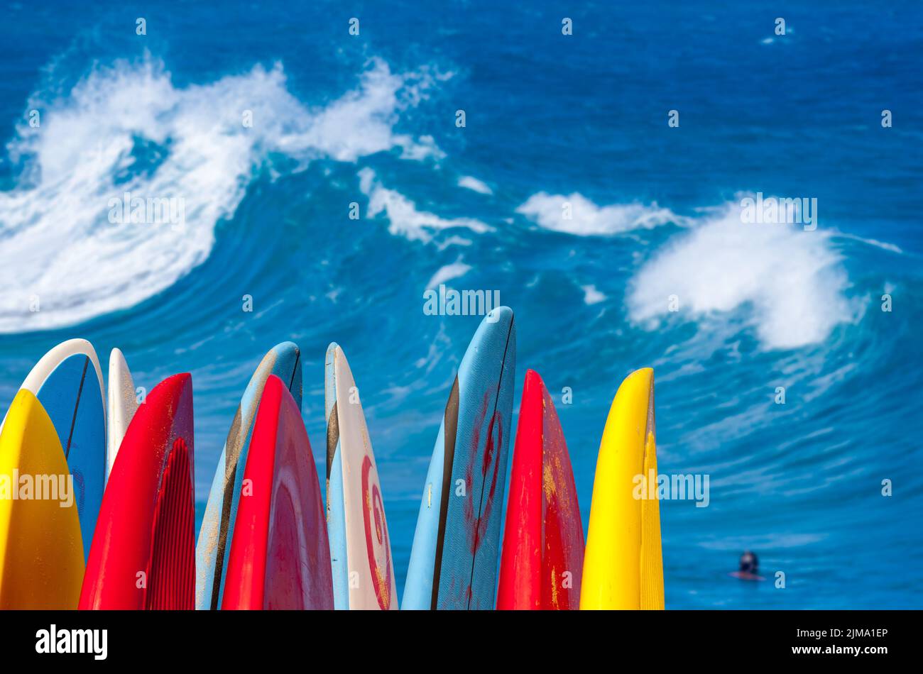 Powerful waves break at Lumahai Beach, Kauai with Surfboards Stock Photo