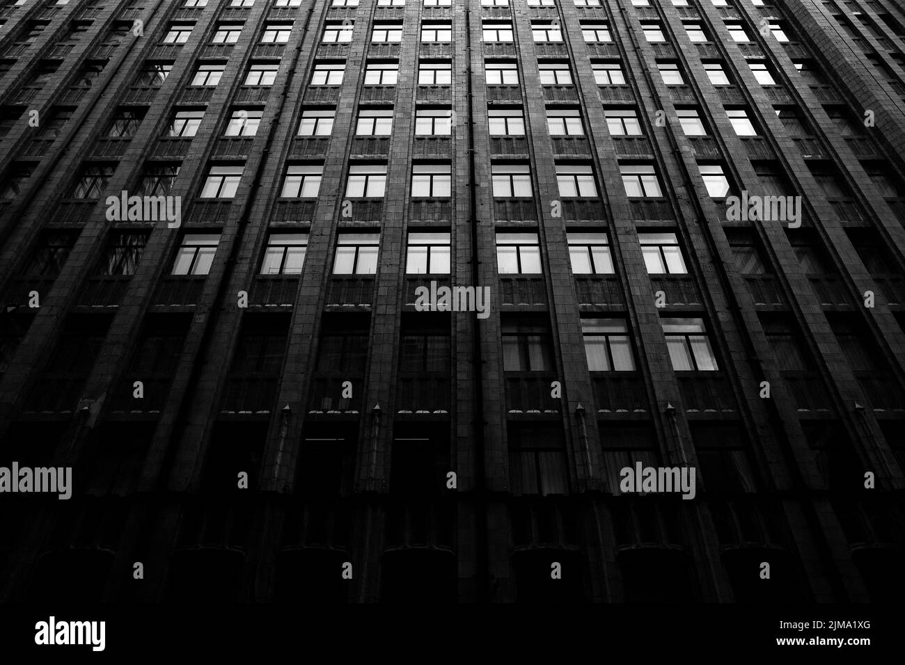 A grayscale low angle shot of wide apartment building Stock Photo