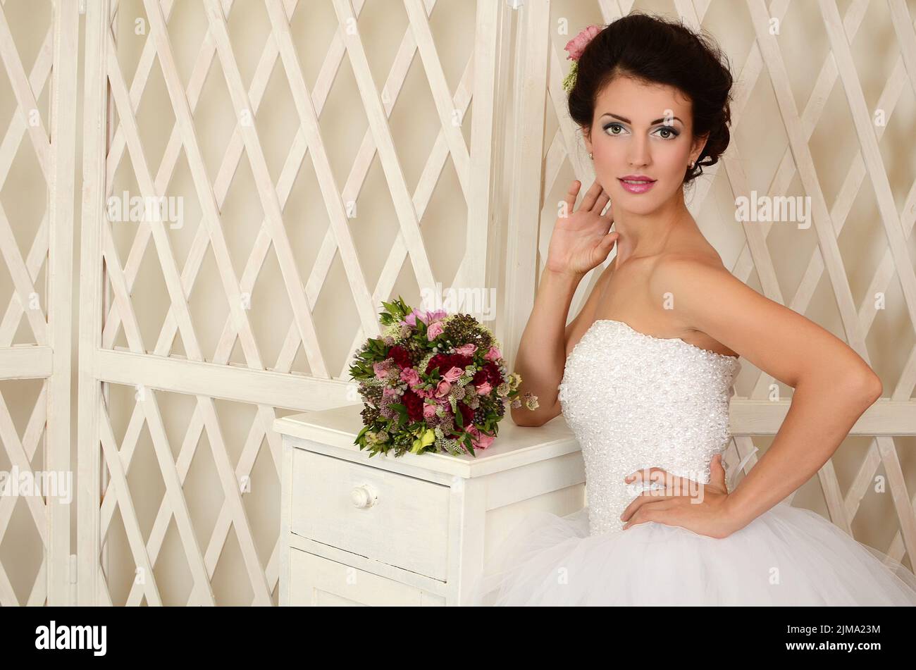 Studio portrait of a young beautiful bride with a wedding bouquet Stock ...
