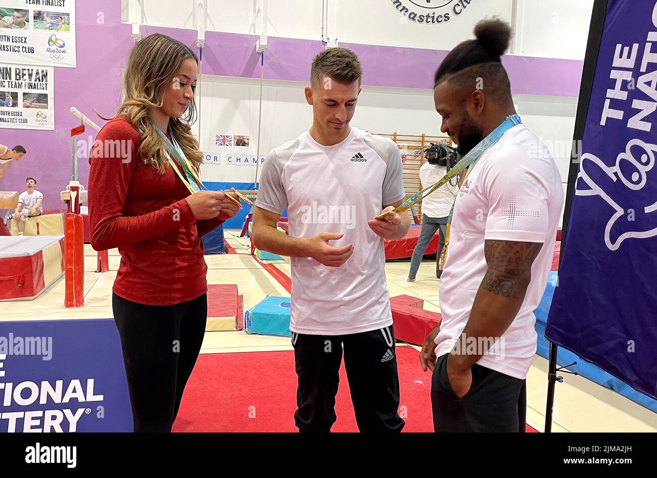 Max Whitlock (centre), Georgia-Mae Fenton (left) and Courtney Tulloch at the South Essex Gymnastics Club, Essex. Picture date: Friday August 5, 2022. Max Whitlock, Courtney Tulloch and Georgia-Mae Fenton surprised a room full of young children who have been supporting Team England throughout the Games. Stock Photo