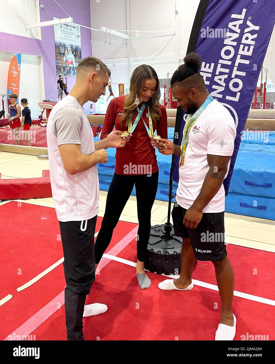 Max Whitlock (left), Georgia-Mae Fenton (centre) and Courtney Tulloch at the South Essex Gymnastics Club, Essex. Picture date: Friday August 5, 2022. Max Whitlock, Courtney Tulloch and Georgia-Mae Fenton surprised a room full of young children who have been supporting Team England throughout the Games. Stock Photo