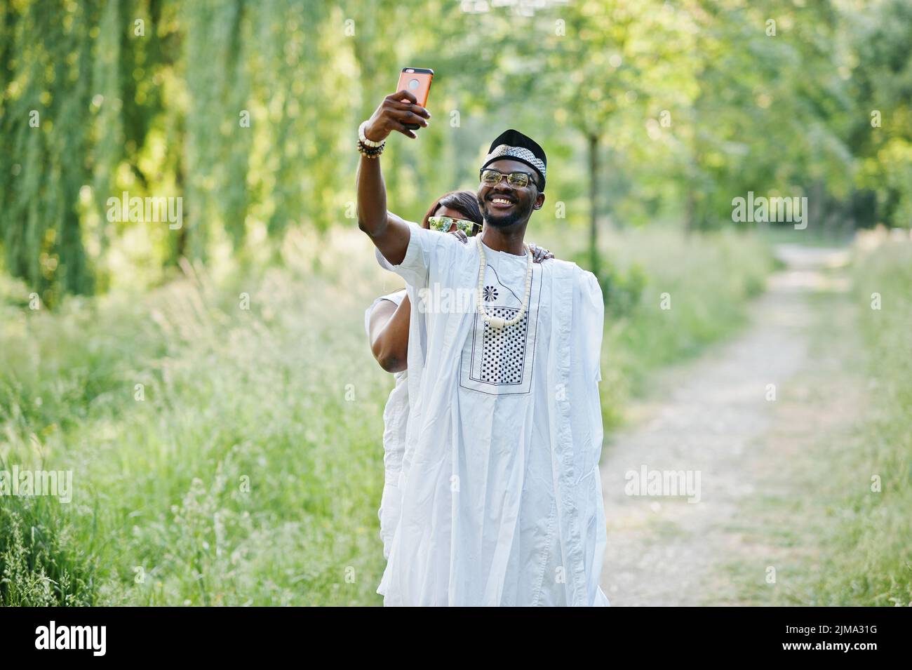 Happy cheerful black african couple in love doing selfie on they phone Stock Photo