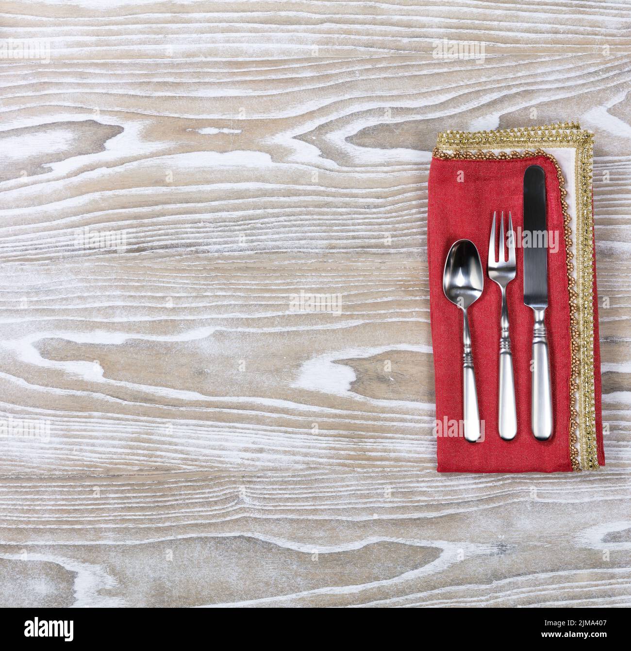 Silverware set and napkin for seasonal holiday on aged white wood Stock Photo