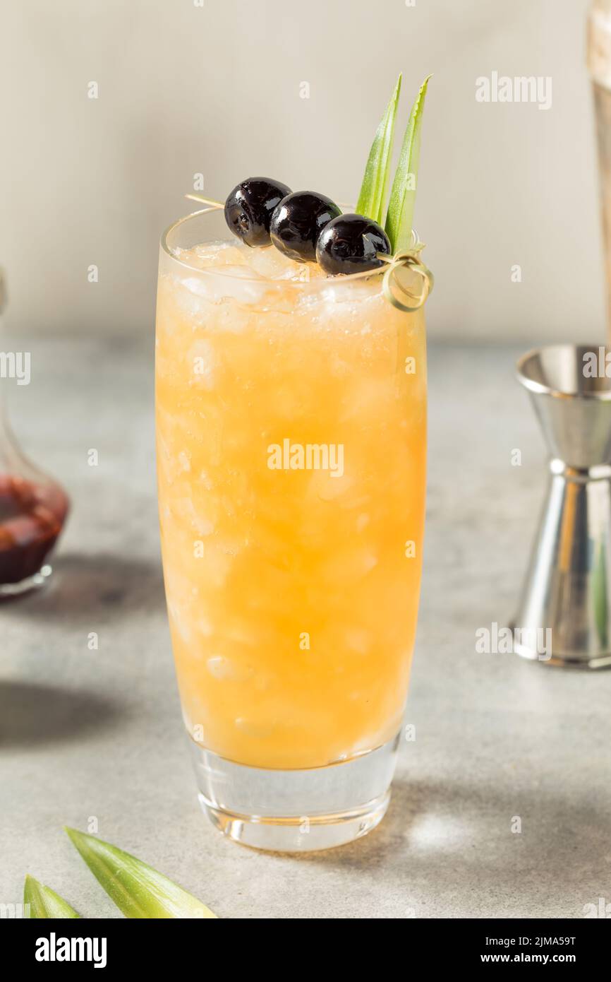 Cold Refreshing Three Dots and a Dash Cocktail with Rum and Pineapple Stock Photo