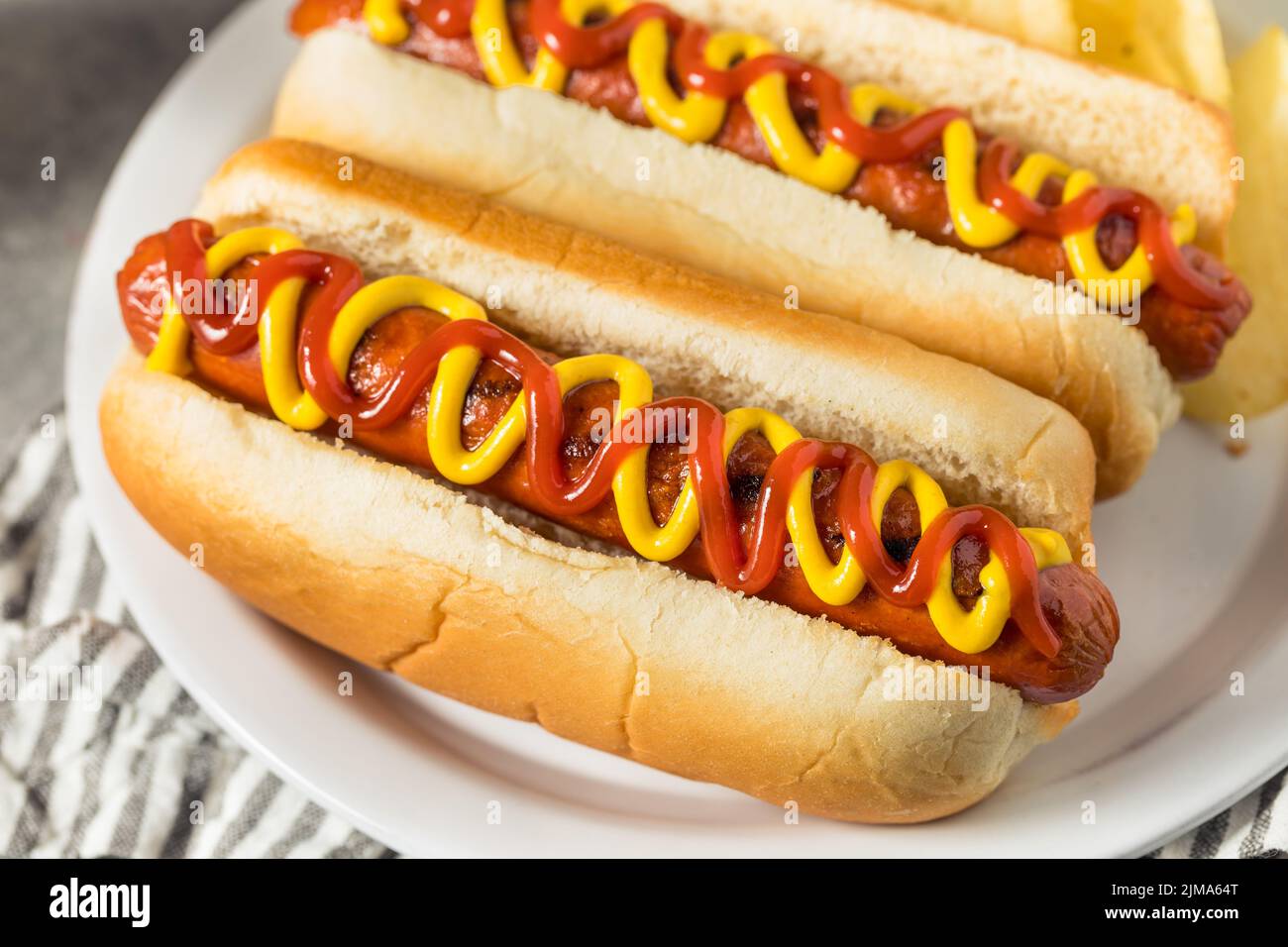 Homemade Hot Dog with Ketchup and Mustard with Potato Chips Stock Photo