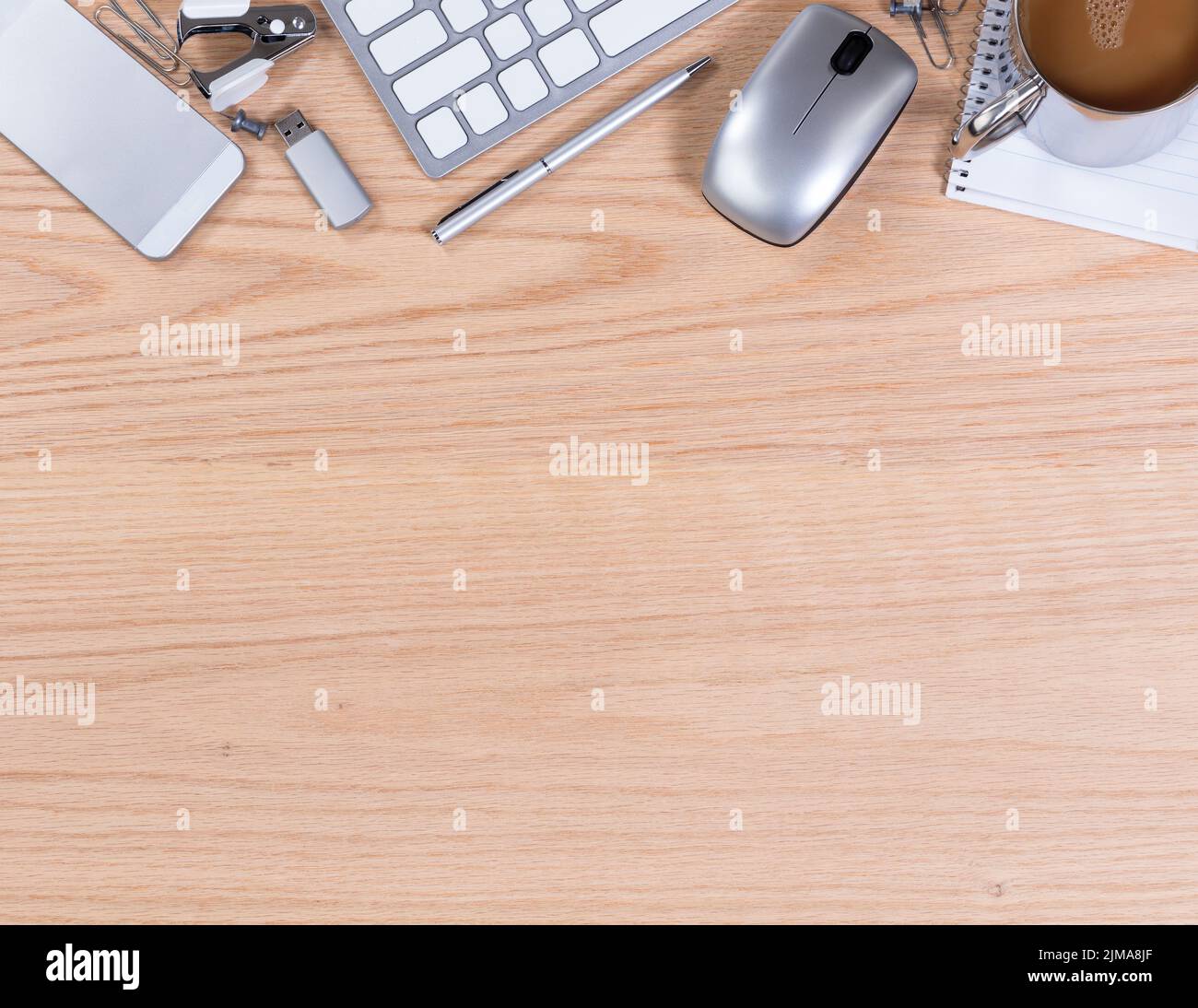 Wooden desktop with various office equipment on upper border of image Stock Photo
