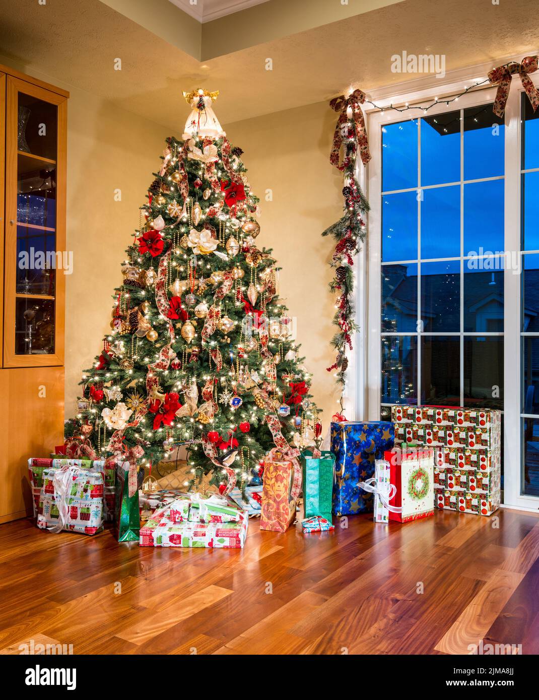 Ornate Christmas Tree in corner of modern home Stock Photo