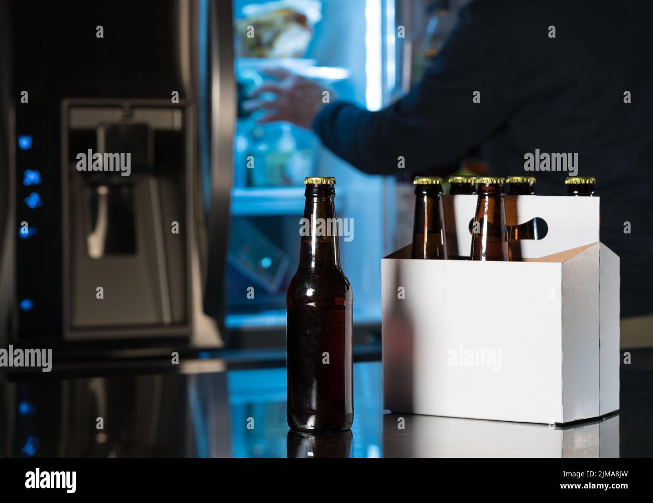Six pack of brown beer bottles on kitchen counter Stock Photo