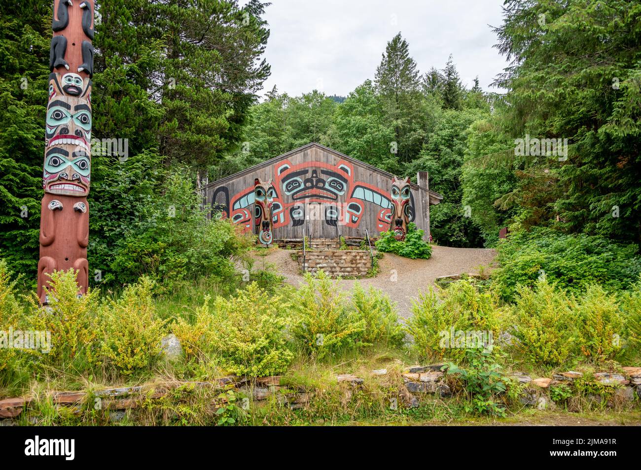 Saxman, Alaska - July 29, 2022: Tlinget totem poles, long house and traditional art. Stock Photo