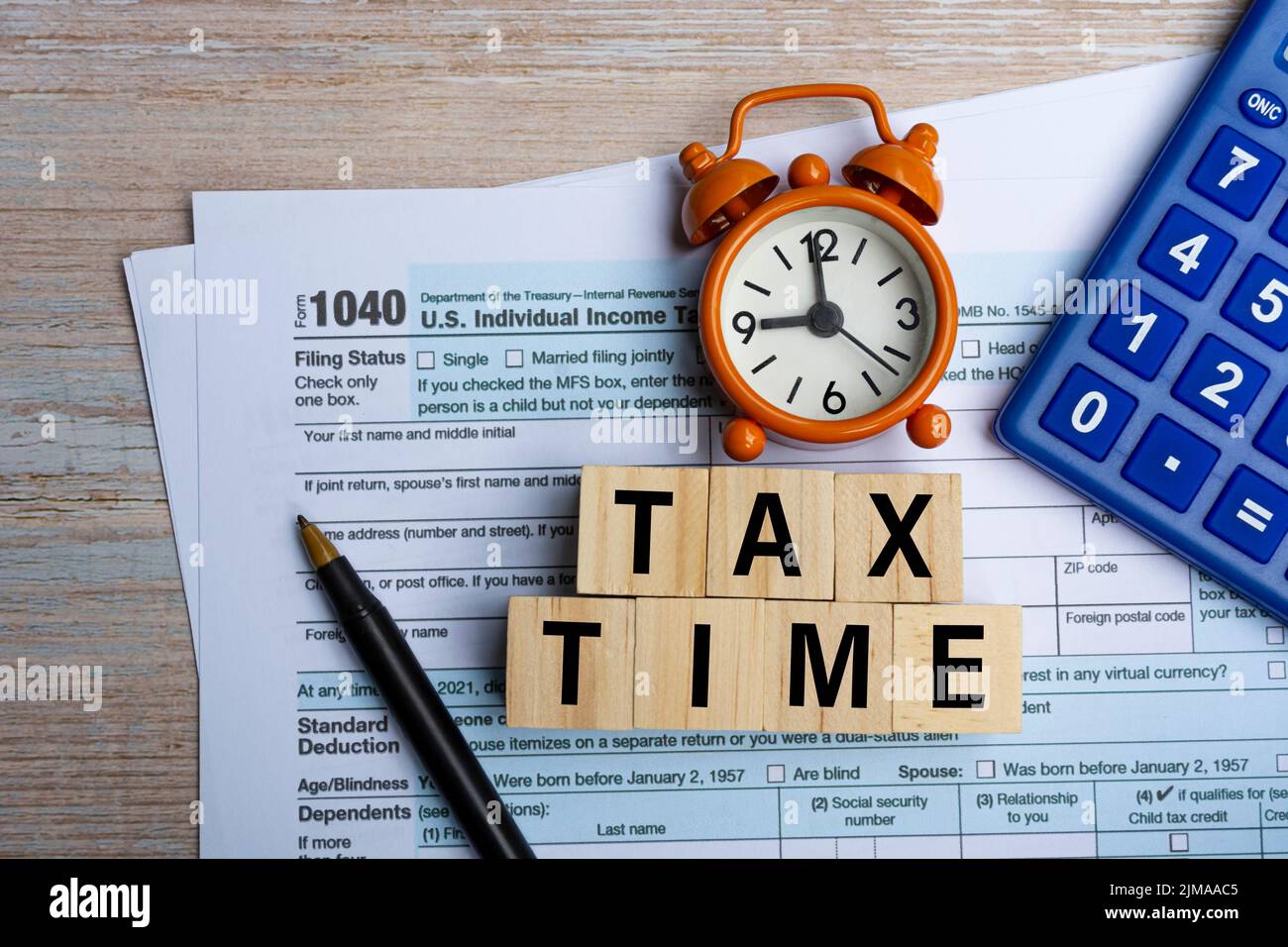 Tax forms 1040. U.S Individual Tax Return with clock and