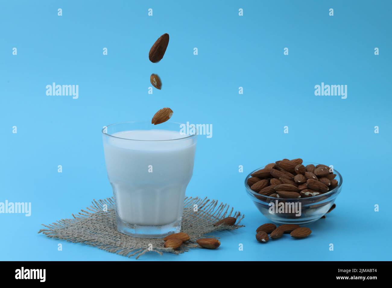 glass of almond milk on the blue background with copy space Stock Photo