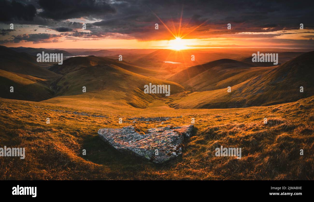 A panoramic sunset from Great Sca Fell in the Lake District looking