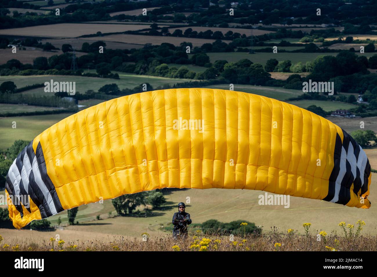 Brighton, August 5th 2022: Paragliders preparing for take-off at Devil's Dyke, in the South Downs National Park, near Brighton, East Sussex Credit: Andrew Hasson/Alamy Live News Stock Photo