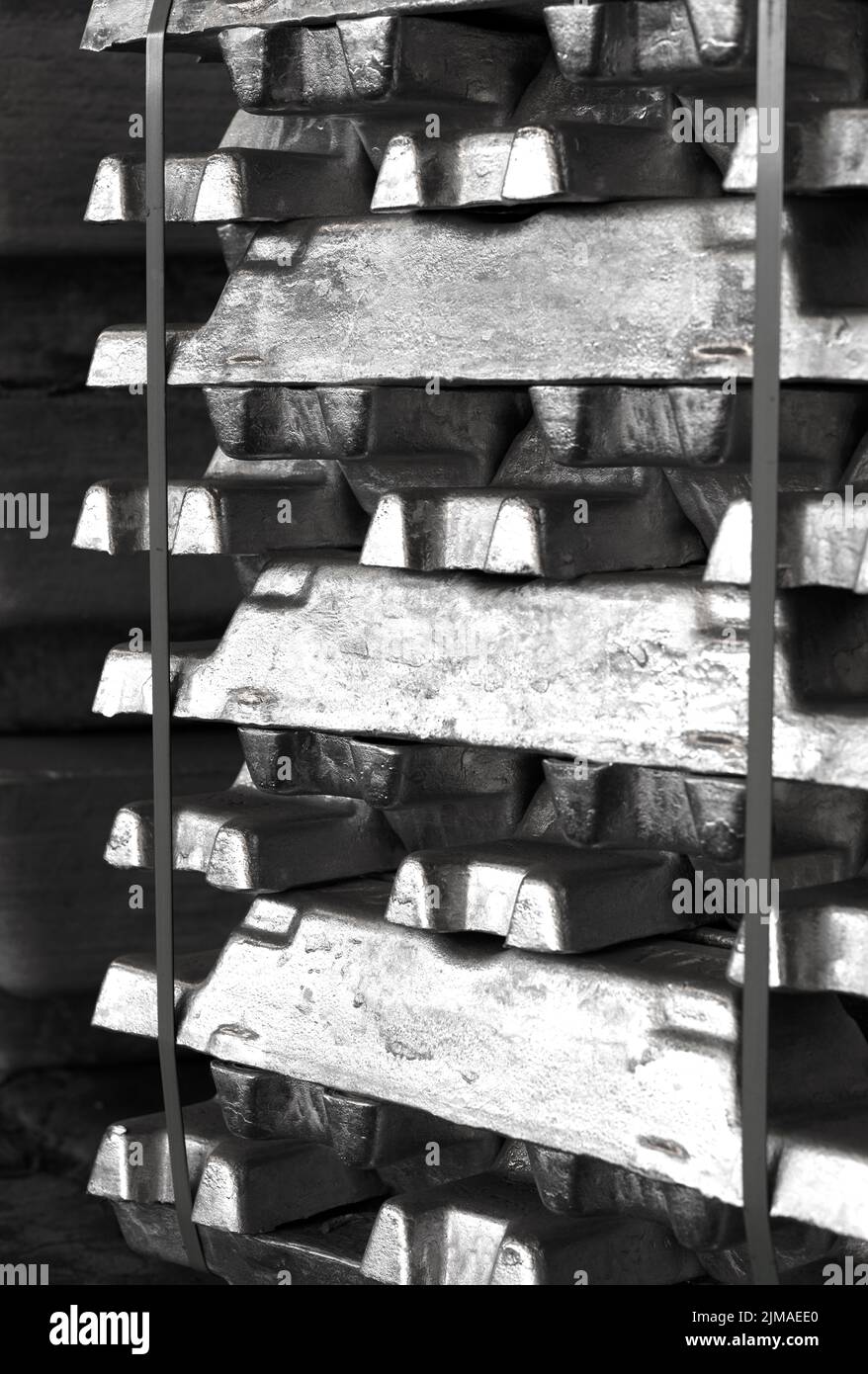 aluminum ingots stacked in the warehouse waiting for meltting, Industrial photo in black and white Stock Photo