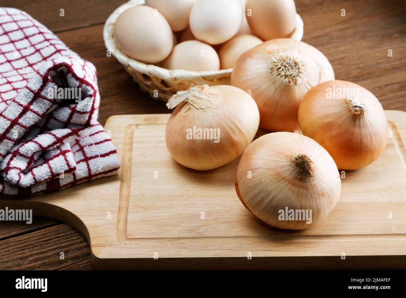 Still life with onions and quail eggs on a kitchen table Stock Photo