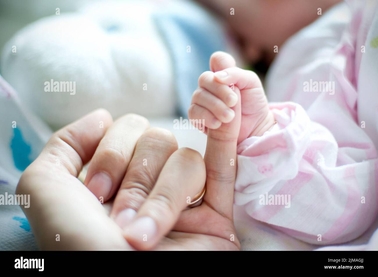 Mother hand holding the baby. Photo taken in the neonatal Gynecological Stock Photo