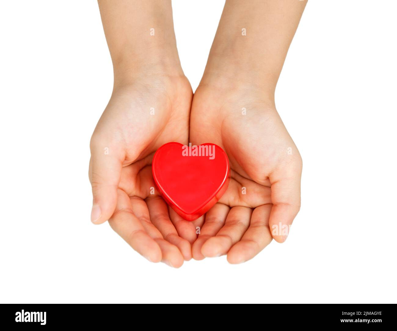Heart care, medical concept. Heart in the hands of a child. Isolated on white. Stock Photo