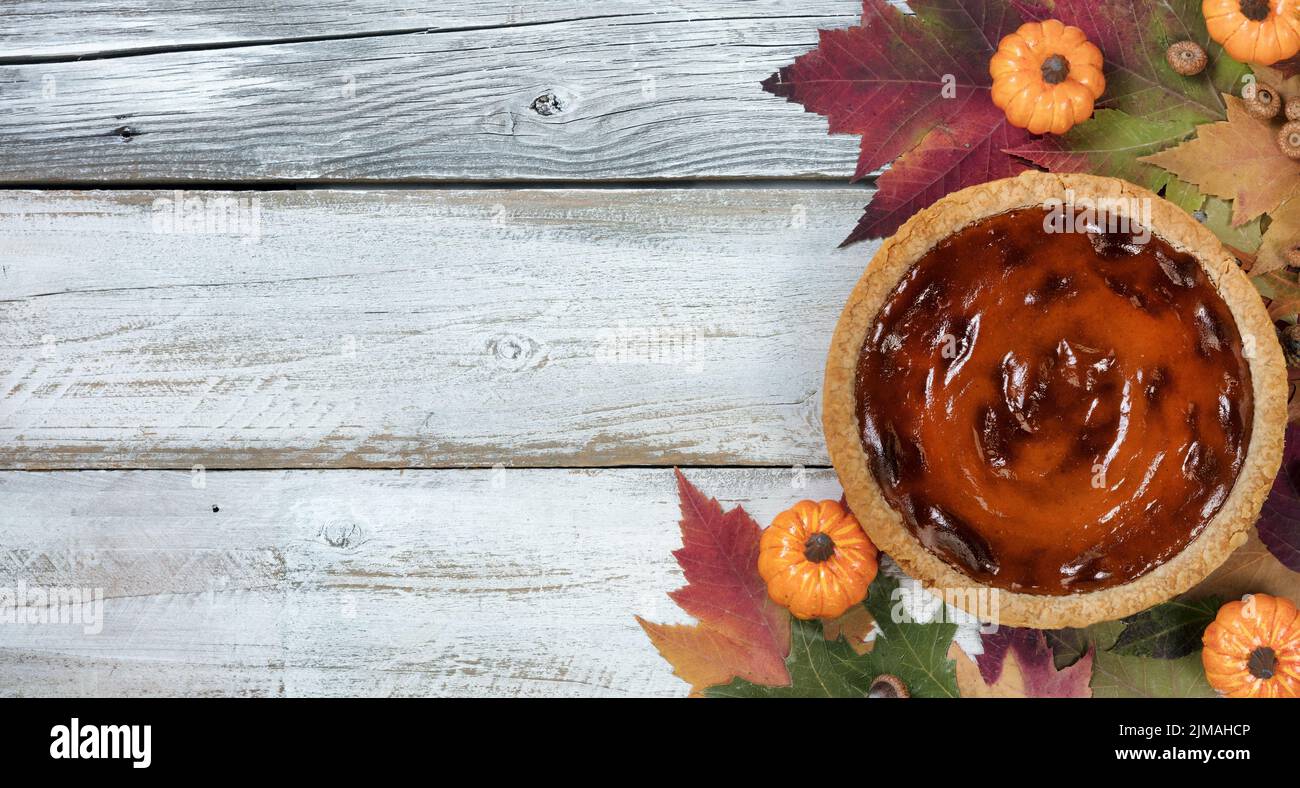 Freshly baked pumpkin pie for the autumn holidays in flay lay format Stock Photo