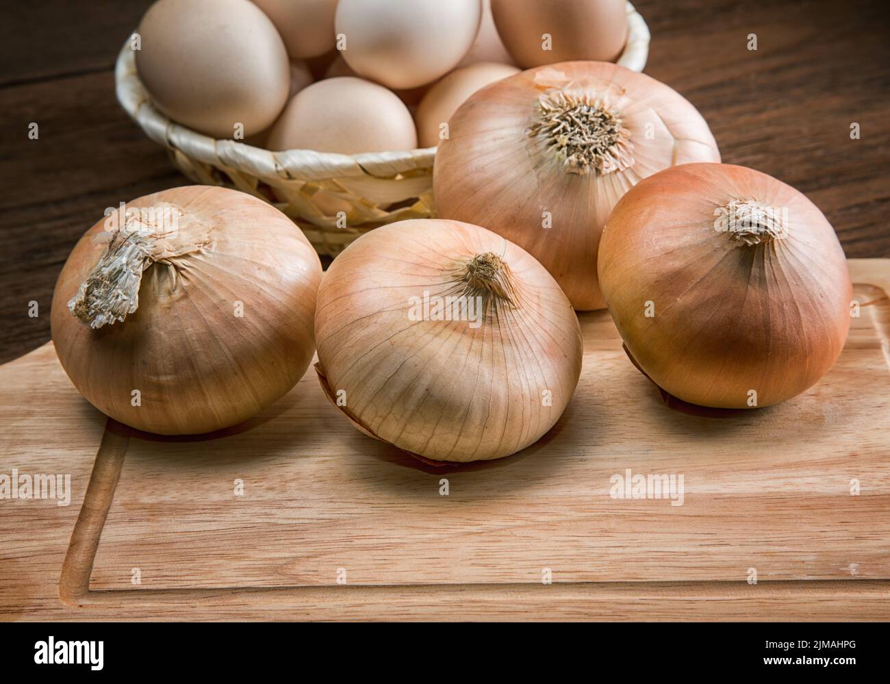 Still life with onions and quail eggs on a kitchen table Stock Photo