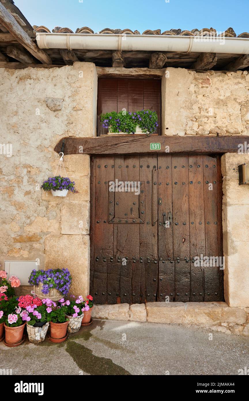 Detail of the wooden door and flowers in Baquedano, Navarra, Spain, Europe Stock Photo