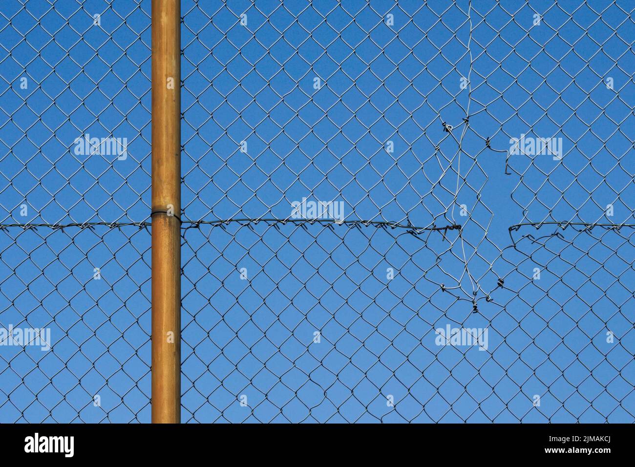 Wire mesh fence with hole Stock Photo Alamy
