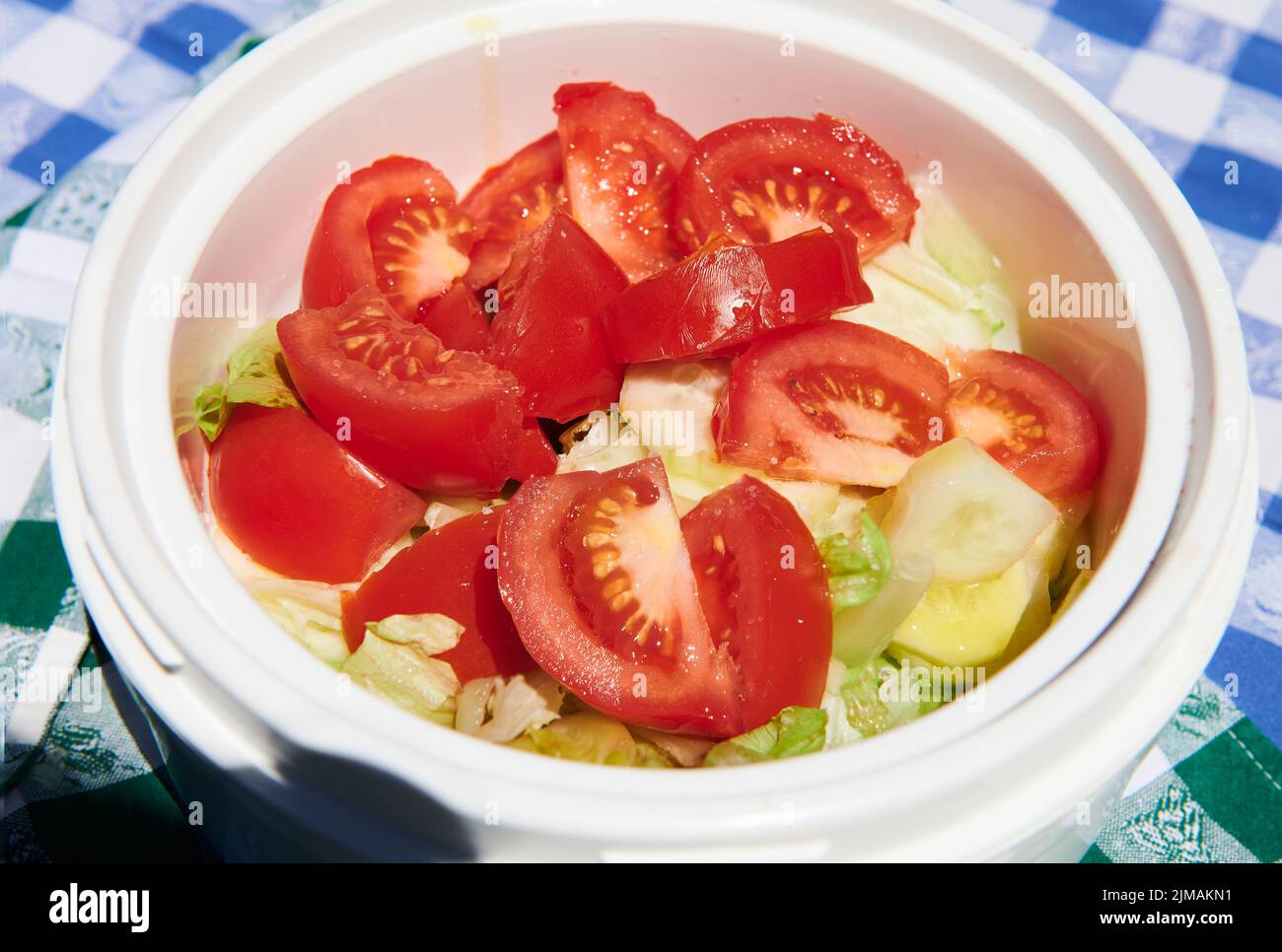 Salad with tomato, lettuce and gherkin into the bowl for day of camp Stock Photo