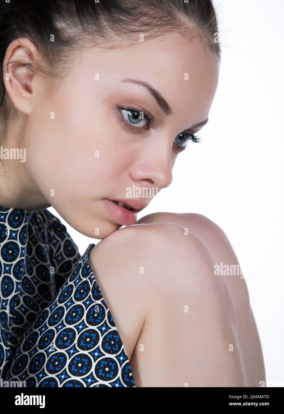 Portrait of a girl close-up. pensively rests his chin on his knee. Stock Photo