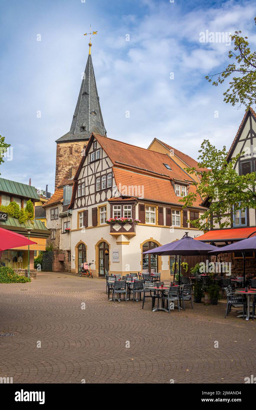 outdoor gastronomy on a small square in eberbach in southern germany. Half-timbered houses and a church in the background Stock Photo