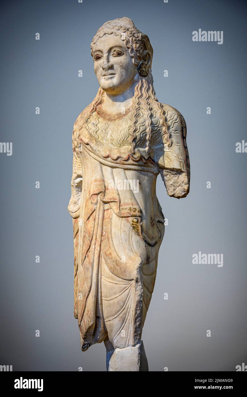 Kore statuette. From the Acropolis in Ahrens.. dressed in a chiton and short ionic himation and she wears round disk earings. There are traces of pain Stock Photo