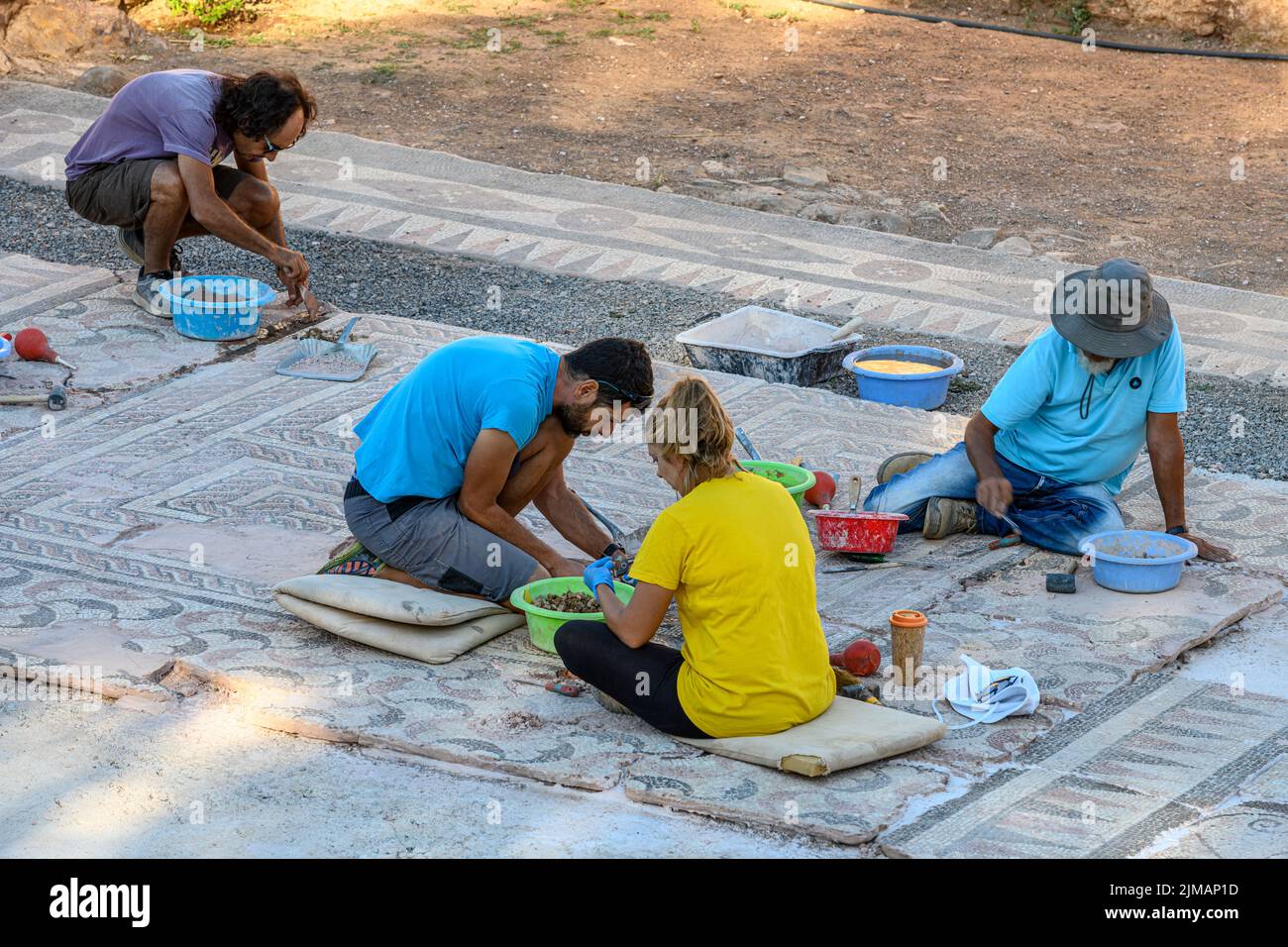 Archaeologists restoring a mosaic floor at ancient Messene (Ithomi), Messinia, Southern Peloponnese, Greece Stock Photo