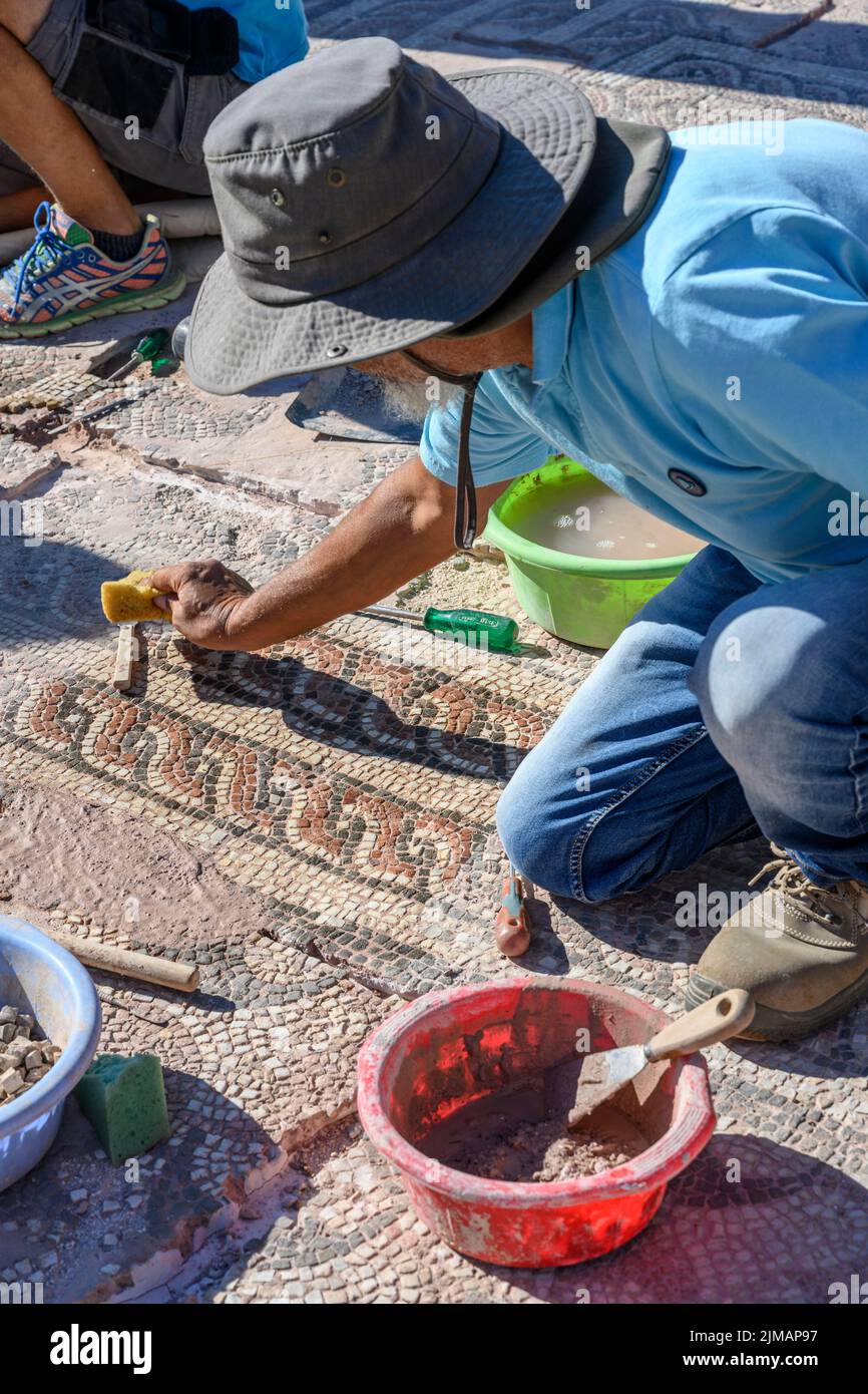 Archaeologists restoring a mosaic floor at ancient Messene (Ithomi), Messinia, Southern Peloponnese, Greece Stock Photo