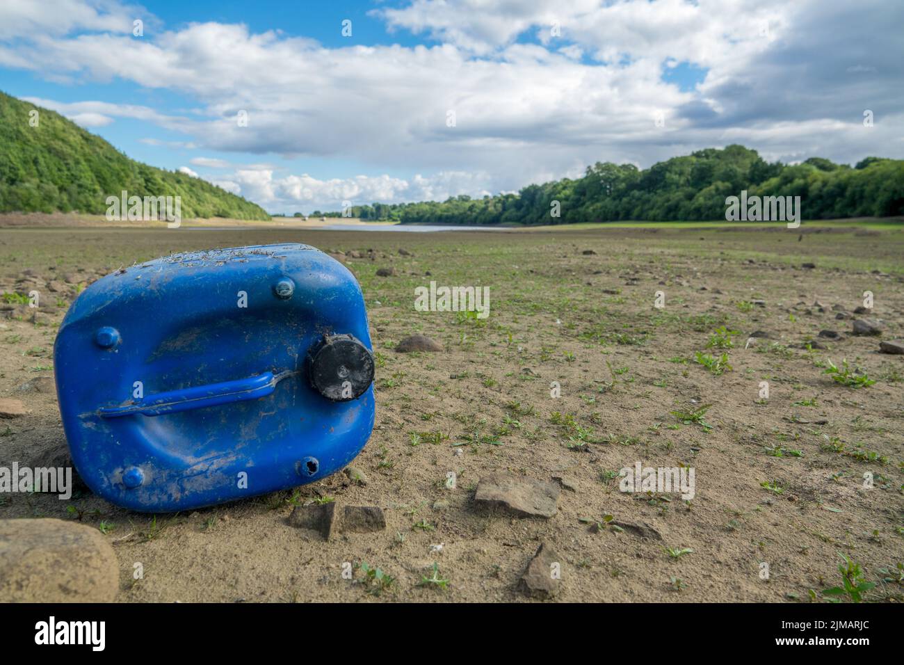 North Yorkshire, UK. 5th August, 2022. Jerry can littered on the empty and dry basin of Lindley Wood Reservoir. Lindley Wood Reservoir, used by Yorkshire Water to supply drinking water to Leeds and surrounding areas, is nearly empty and dry.  Credit: Bradley Taylor / Alamy News Stock Photo