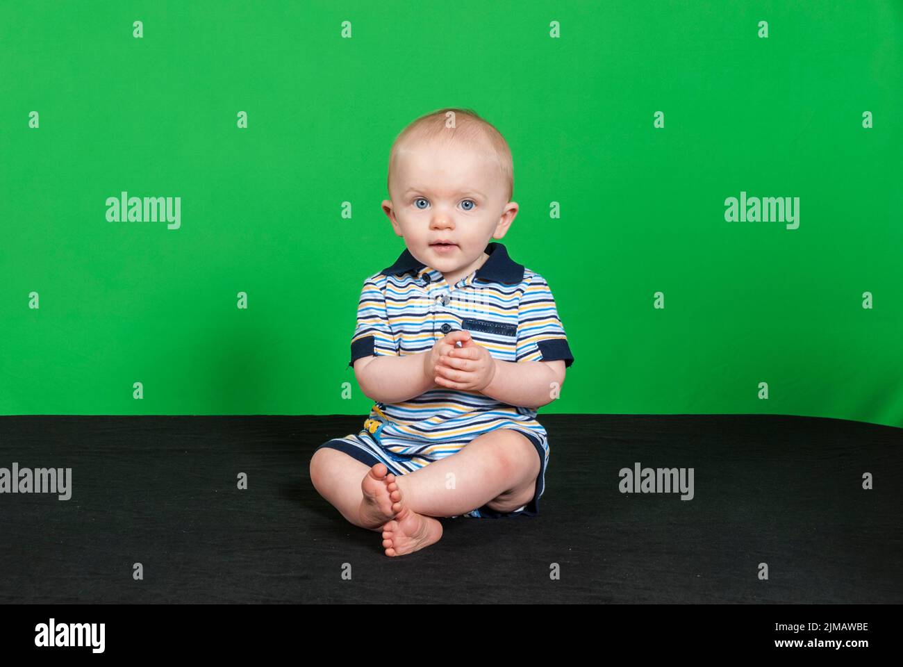 10 Month Old Baby Boy on a Green Background pt 2 Stock Photo Alamy