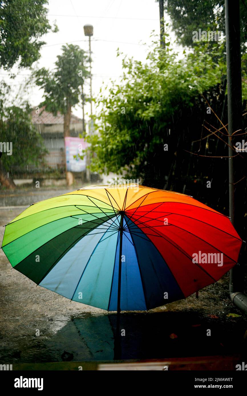Rainbow umbrella in the rainy season Stock Photo Alamy