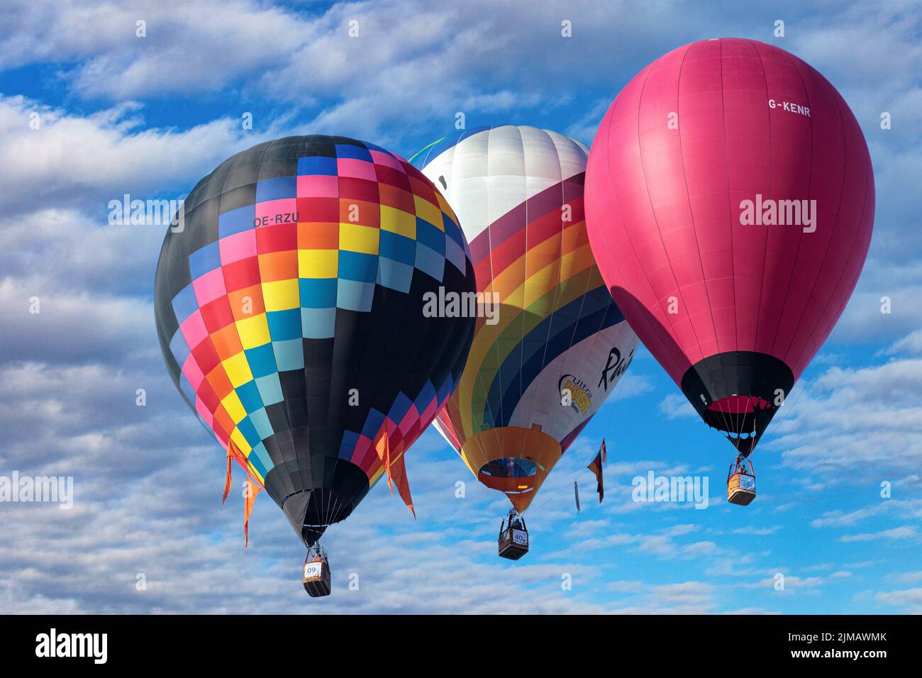 A view of tree colorful hot air balloons in the sky on a sunny day ...