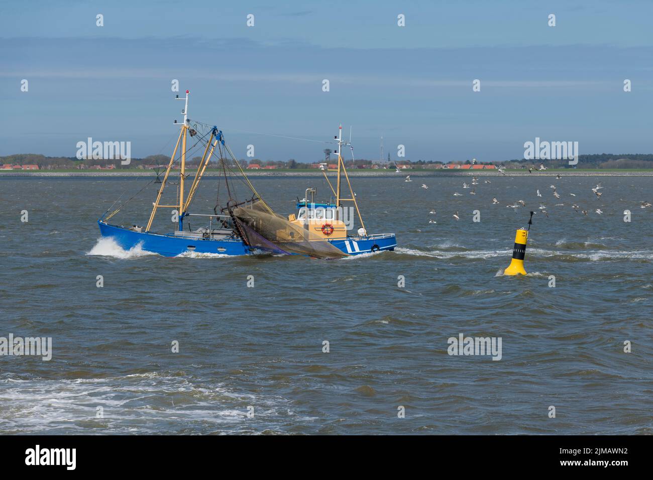 Fishing boat on the Wadden Sea near the island Ameland Stock Photo