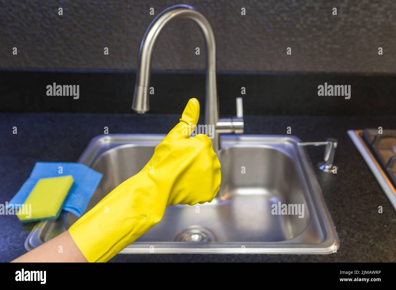 Great concept of domestic cleaning, hand with glove making positive