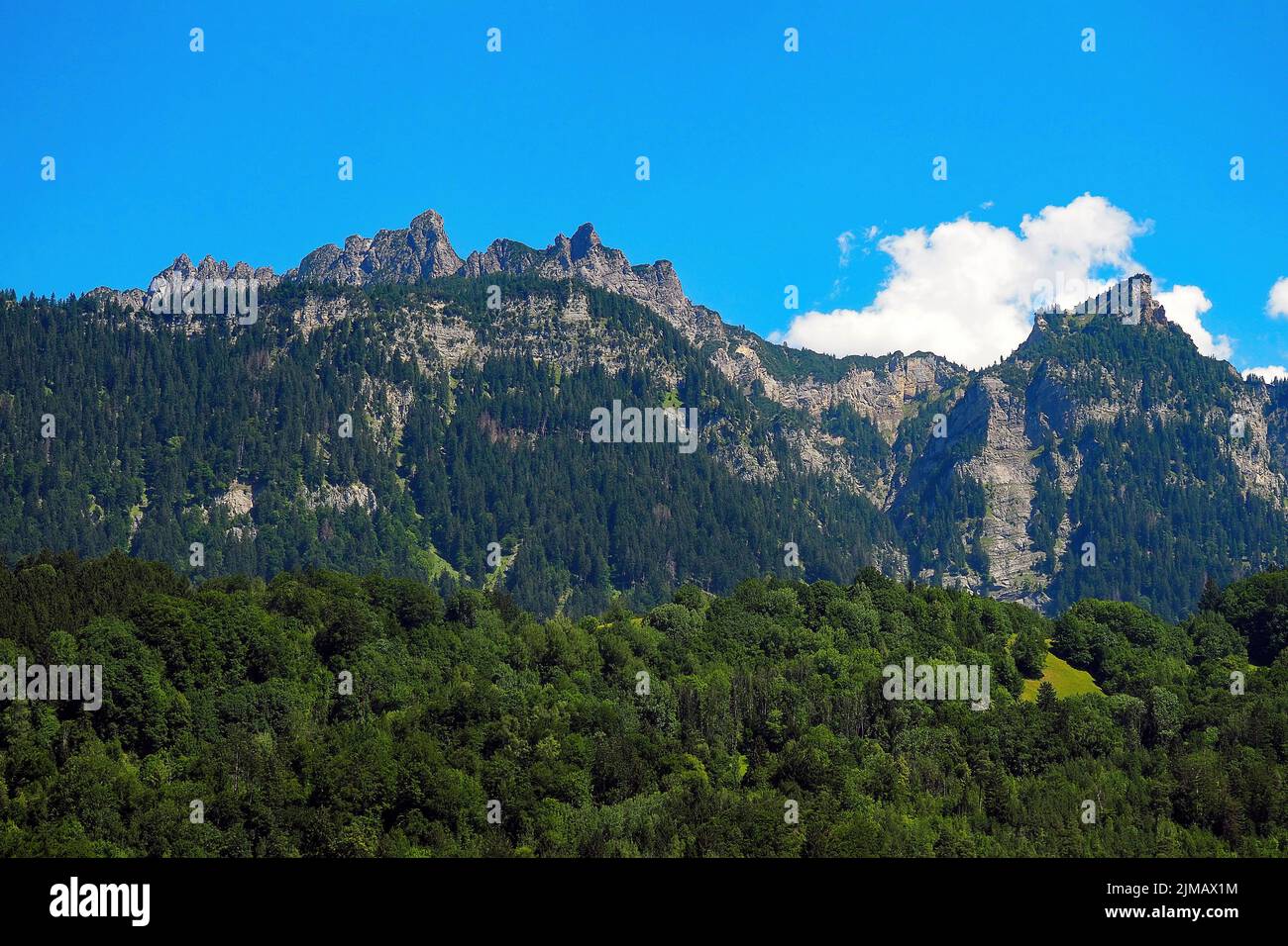 Mountain scene in Bludenz Austria  with blue sky and fluffy clouds Stock Photo
