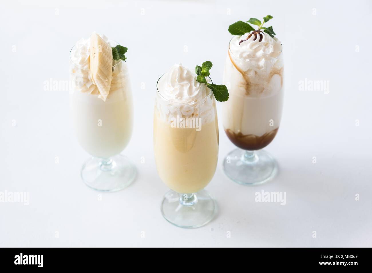 assorted milkshakes minimal layout three glasses Stock Photo