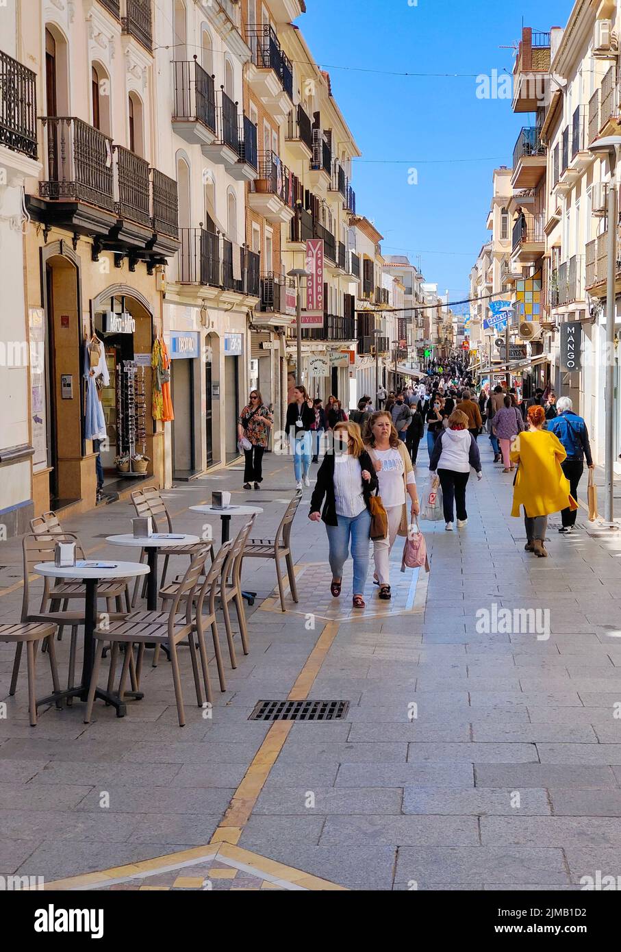 RONDA SPAIN - MAY 2022. Tourist walking in the shop street of Ronda in a sunny day. Stock Photo