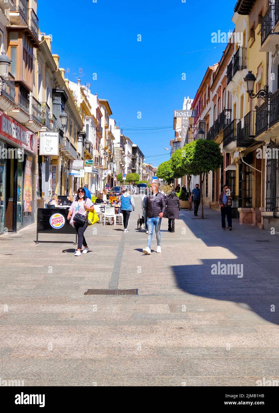 RONDA SPAIN - MAY 2022. Tourist walking in the shop street of Ronda in a sunny day. Stock Photo