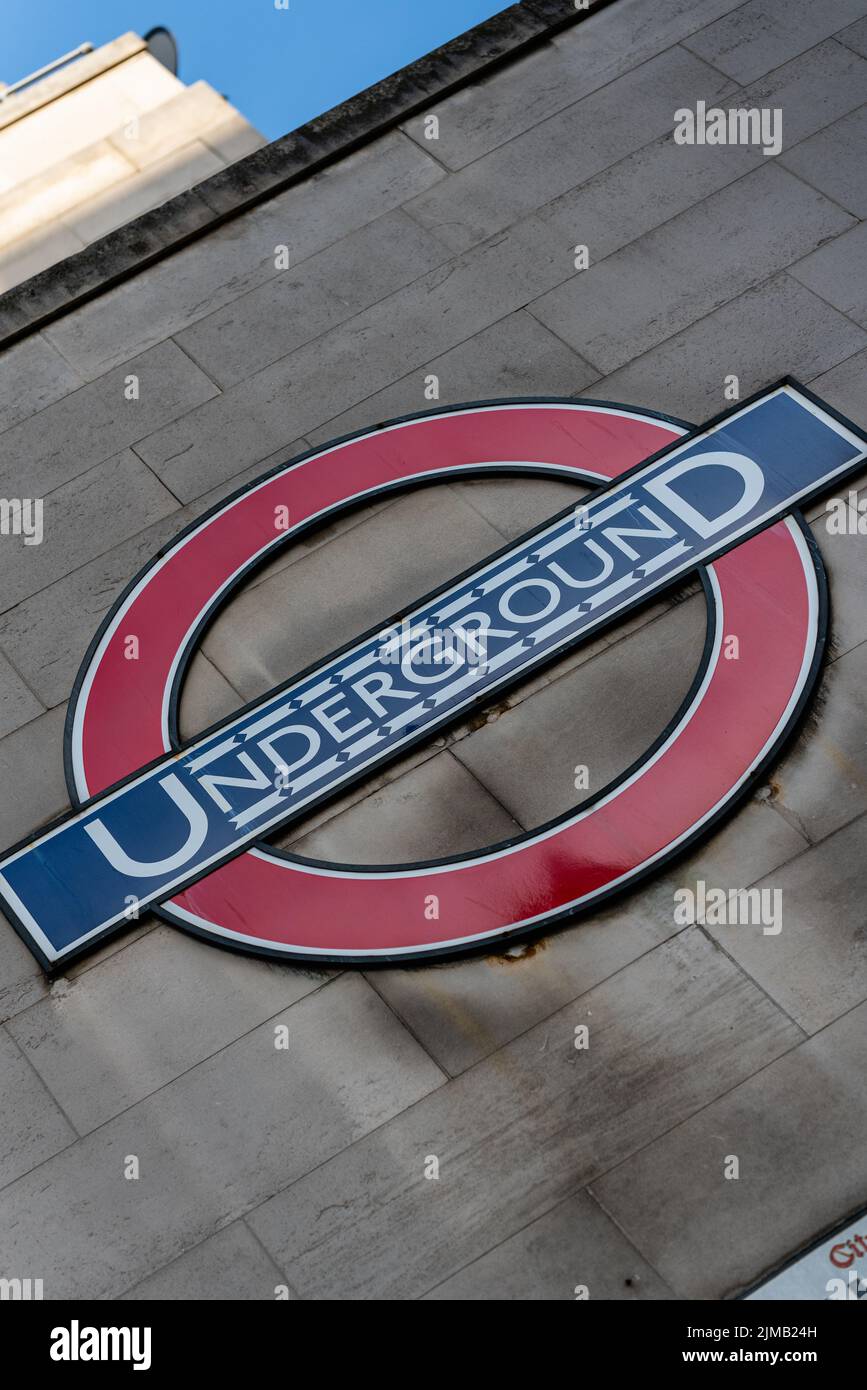 a vertical shot of a TFL London Underground signage on the side of a building - close-up Stock Photo