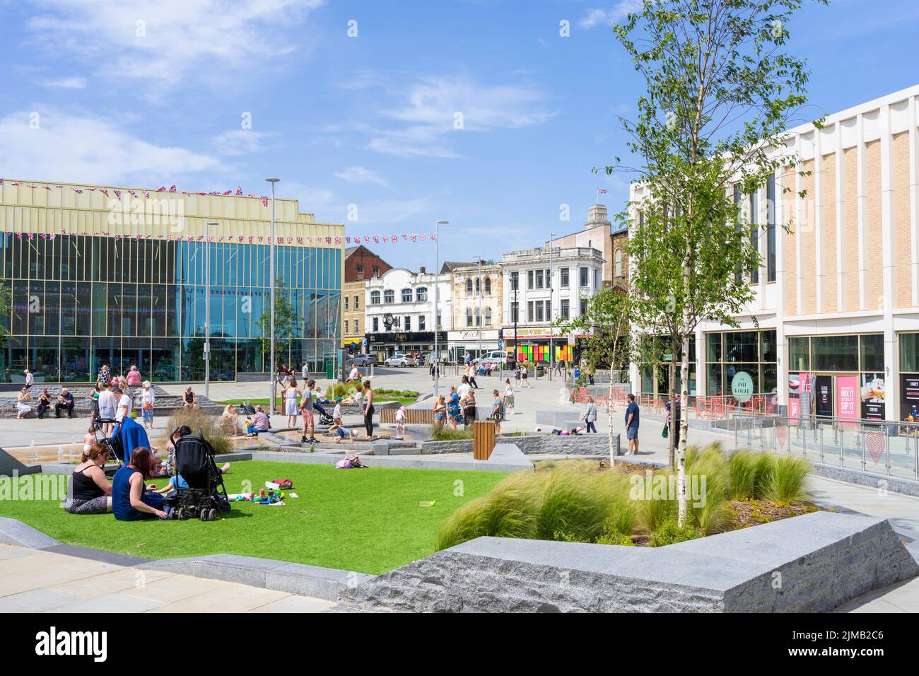 Barnsley Library or The Lightbox People enjoying the sun in Glass Work's square Barnsley South Yorkshire West Riding of Yorkshire England UK GB Europe Stock Photo