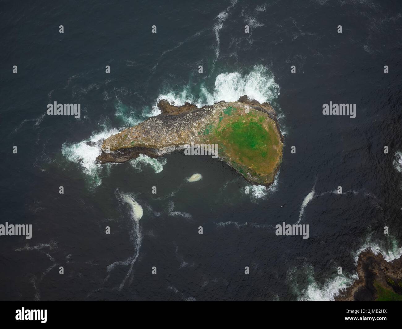 Shooting from a drone. Stone island in the shape of a fish in the ...