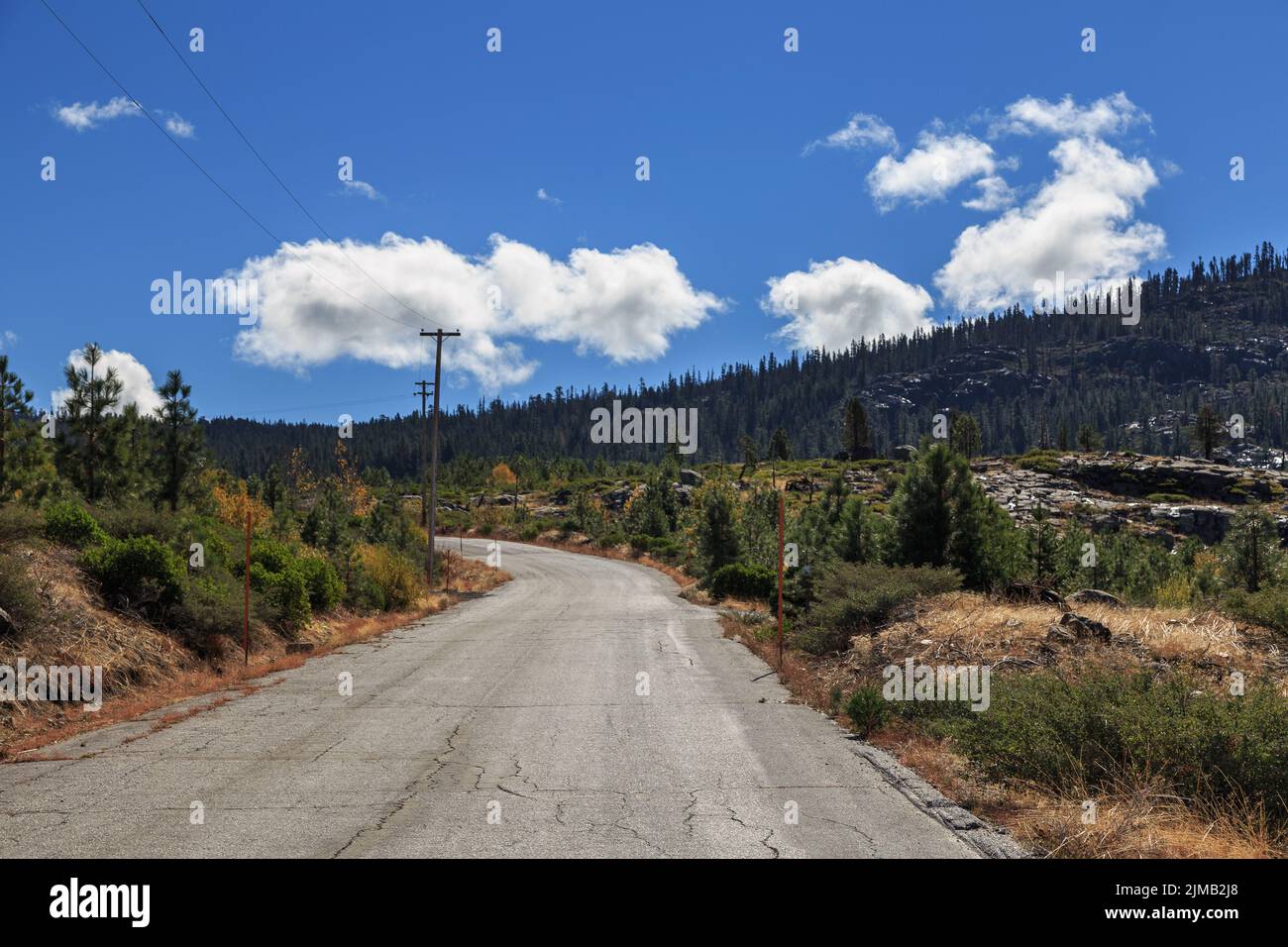 Paved country road leads through mountains on the California side of the Sierra Nevada. Stock Photo