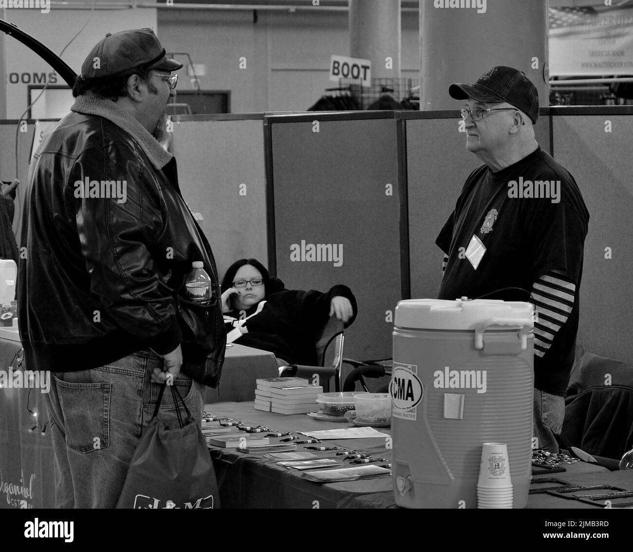 A grayscale shot of bored sellers and a buyer at a store in Waterbury, Connecticut, USA Stock Photo