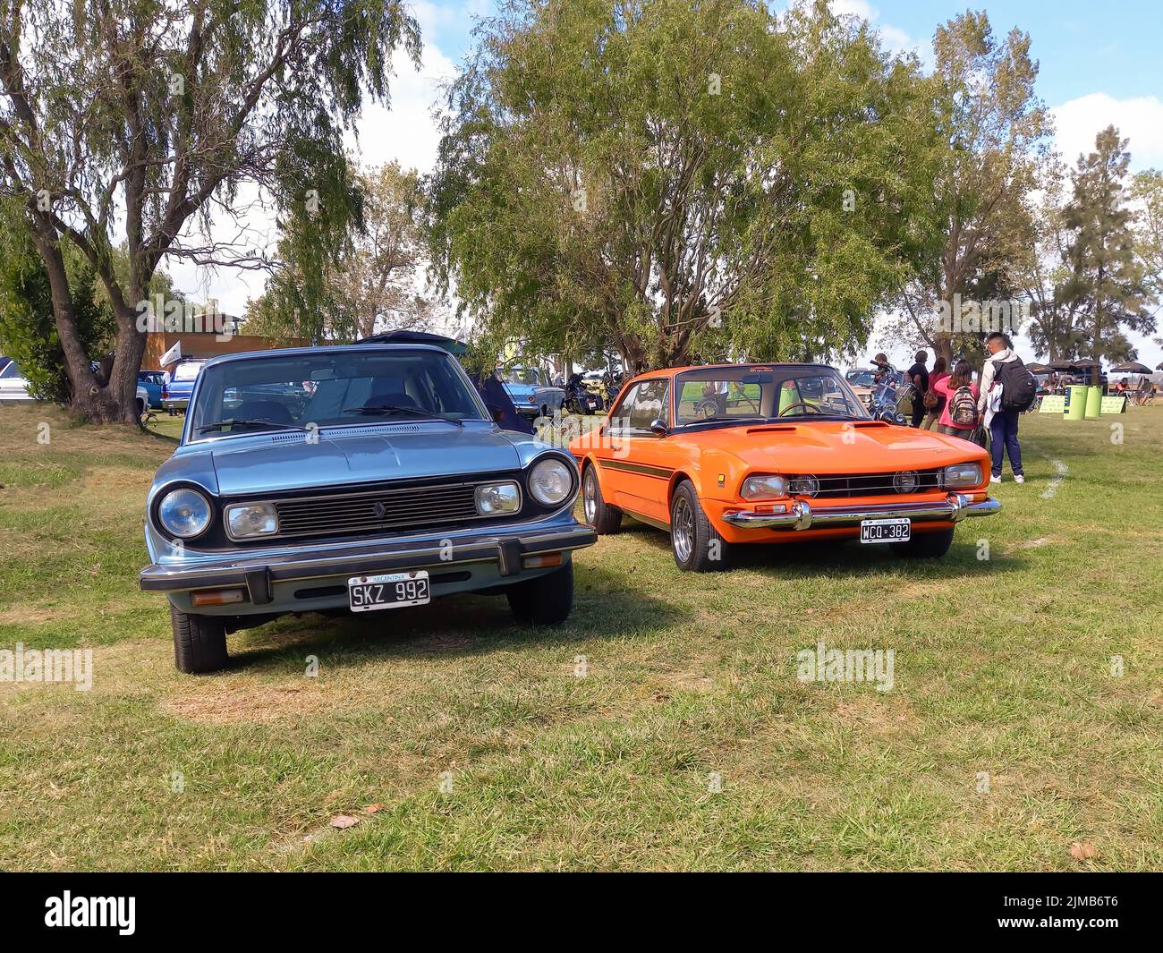 Old Renault Torino four door sedan and Lutteral Comahue sport coupe 1970s in the countryside. Nature, grass, trees. Classic car show. Copyspace Stock Photo