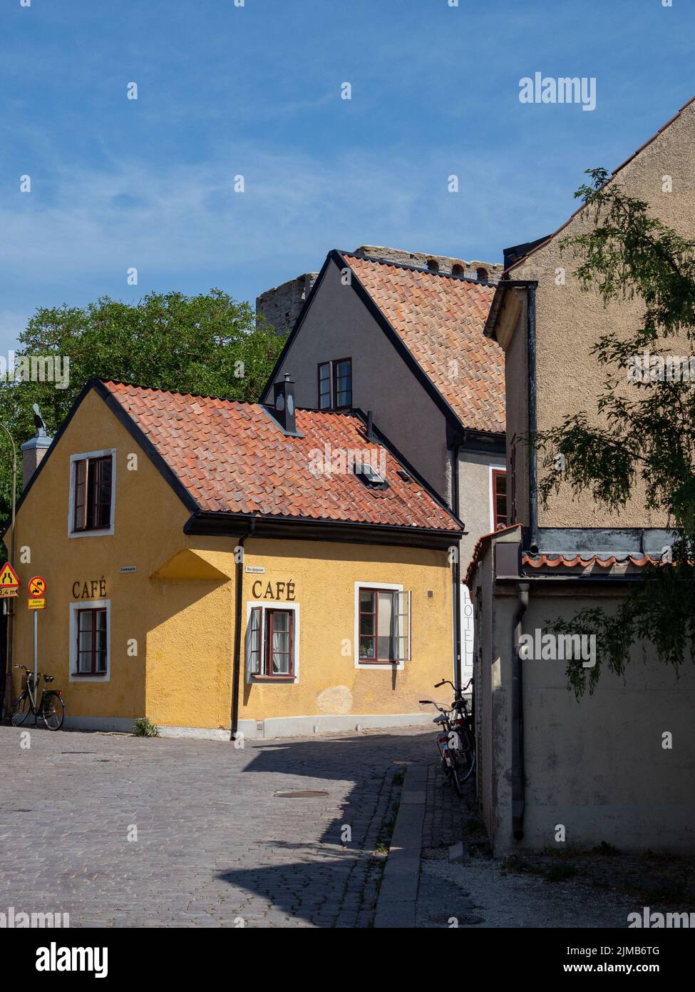 A vertical shot of cozy Cafe Gula Huset HB - Cafe in Visby, Sweden under blue sky Stock Photo