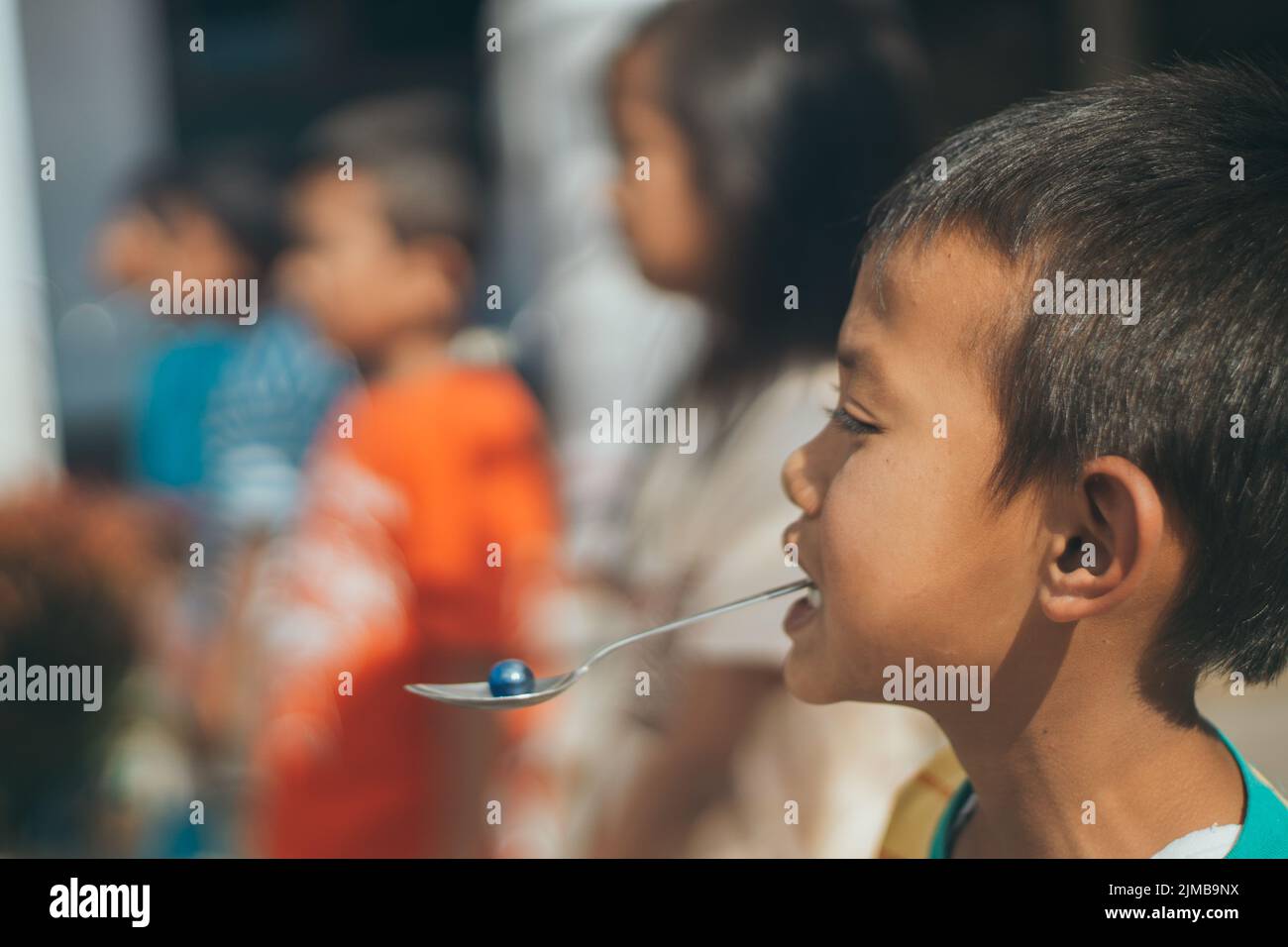 Getasan, Semarang, Indonesia - August 17, 2017: kids play Bite the spoon of marbles to celebrate indonesia independence day Stock Photo