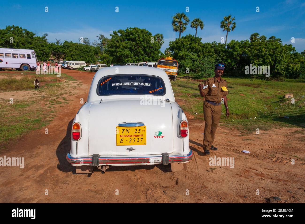 Indian policeman next to a car policing an open air celebration event in Mahabalipuram. Stock Photo